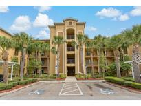 Beautiful condo building showcasing tropical landscaping and accessible parking spots at 6519 Grand Estuary Trl # 101, Bradenton, FL 34212