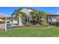 Charming home with well-manicured front lawn and beautiful tropical landscaping at 6621 The Masters Ave, Lakewood Ranch, FL 34202