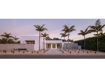 Modern home exterior featuring sleek lines, minimalist landscaping, and striking palm trees at twilight at 1354 Westway Dr, Sarasota, FL 34236