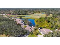Stunning aerial view of homes overlooking the golf course and lake at 3008 Highlands Bridge Rd, Sarasota, FL 34235