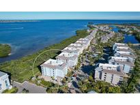 Beautiful aerial view of waterfront condos with stunning bay views and lush landscaping at 396 Aruba Cir # 302, Bradenton, FL 34209