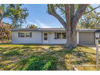 Charming single-story home featuring a well-maintained lawn and attached garage at 4461 Maceachen Blvd, Sarasota, FL 34233