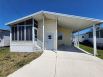 A charming single-story home with a covered carport and cozy screened-in porch, perfect for relaxing and enjoying the outdoors at 4923 5Th Street W Ct, Bradenton, FL 34207