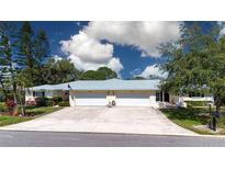 Charming home with a two-car garage, beautiful landscaping, and a spacious driveway at 5621 Palm Aire Dr, Sarasota, FL 34243