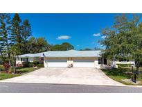 Charming single story home with a well manicured lawn, two-car garage, and beautiful landscaping at 5621 Palm Aire Dr, Sarasota, FL 34243