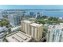 Stunning aerial view of a high-rise residential building with ocean views in a vibrant urban setting at 750 N Tamiami Trl # 814, Sarasota, FL 34236