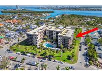 Beautiful aerial view of a condo community with a pool, water views and convenient beach access at 1001 Benjamin Franklin Dr # 510, Sarasota, FL 34236