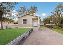 Charming single-story home featuring a well-manicured lawn and a quaint walkway leading to the front door at 11936 82Nd E St, Parrish, FL 34219