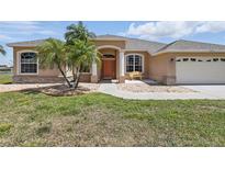 Charming single-story home featuring a manicured lawn and decorative stone accents and covered entry at 3218 45Th E Way, Bradenton, FL 34203
