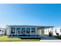 Charming single-story home featuring a screened-in porch and attached carport in a well-maintained community at 3232 Ash Ter, Sarasota, FL 34237