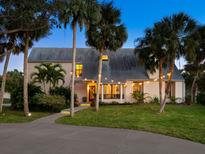 Charming home featuring lush landscaping, a welcoming walkway, and inviting exterior lighting at 3648 Beneva Oaks Blvd, Sarasota, FL 34238