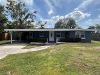 Charming single story home featuring a covered entrance, manicured shrubs, and a well kept lawn at 3826 Clover Ln, Sarasota, FL 34233