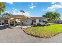Charming single-story home featuring a covered carport, manicured lawn, and welcoming front entrance at 5020 Live Oak Cir, Bradenton, FL 34207
