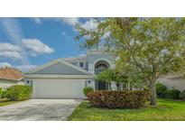 Charming two-story home with a well-manicured lawn and a two-car garage at 6433 Blue Grosbeak Cir, Lakewood Ranch, FL 34202