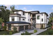 Modern luxury home with multi-level balconies and an attached garage at 7324 Point Of Rocks Rd, Sarasota, FL 34242