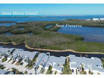 Wonderful aerial view of a condo community near Anna Maria Island and the Neal Preserve with beautiful landscaping at 1218 Spoonbill Landings Cir, Bradenton, FL 34209