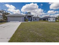 Charming single-story home with a well-maintained lawn, attached garage, and inviting entrance at 1269 Rasp Ct, North Port, FL 34288