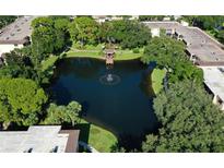 Beautiful aerial view of a well-maintained community with a tranquil pond and lush landscaping at 315 30Th W Ave # B214, Bradenton, FL 34205