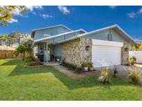 Charming two-story home with stone accents, a well-manicured lawn, and a two car garage at 3809 21St W Ave, Bradenton, FL 34205