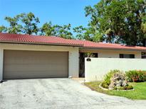 Charming home featuring a terra cotta tile roof, neutral stucco, and an attached two-car garage at 3818 Sun Eagle Ln, Bradenton, FL 34210