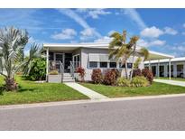 Charming single-story home with well-maintained landscaping and inviting front entrance, carport, and mature palm trees at 4304 14Th E St, Ellenton, FL 34222