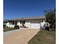 Charming single-story home featuring a well-maintained lawn and attached garage with ample parking space at 1036 Hope St, Venice, FL 34285