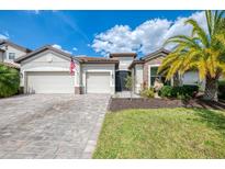 Stunning two-story home featuring a paver driveway and a two-car garage at 18032 Polo Trl, Bradenton, FL 34211