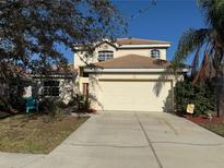 Charming two-story home showcasing a well-maintained lawn and a spacious two-car garage in a quiet neighborhood at 227 Golden Harbour Trail Way, Bradenton, FL 34212