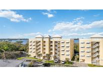 Beautiful exterior of a condo complex with bright paint, open-air walkways, and well-maintained landscaping at 280 Hidden Bay Dr # 202, Osprey, FL 34229