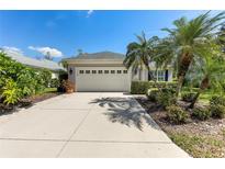 Charming home featuring a spacious two-car garage, lush landscaping, and a well-maintained driveway at 5515 Simonton St, Bradenton, FL 34203