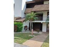 Charming condo exterior with walkway, attractive landscaping, and second floor balcony at 6012 Oak Creek Ln # 1913, Bradenton, FL 34210