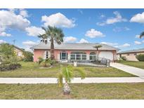 Charming single-story home featuring a well-manicured lawn and attractive landscaping at 6023 Mayberry Ave, North Port, FL 34287