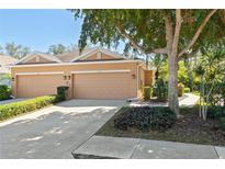 Charming single-Gathering home with a two-car garage and beautifully landscaped front yard with mature tree at 7317 Emma Rd, Bradenton, FL 34209