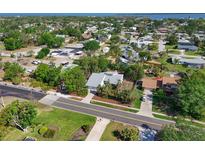 Expansive aerial view of neighborhood featuring mature trees, manicured lawns, and glimpses of waterways at 7816 15Th Nw Ave, Bradenton, FL 34209