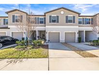 Charming townhome with a well-manicured lawn and gray shutters at 9743 Pembrooke Pines Dr, Sun City Center, FL 33573