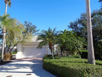 Inviting single-story home with a 2-car garage and lush landscaping at 1354 Tearose Pl, Sarasota, FL 34239