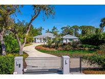 Beautiful property with a circular drive, meticulous landscaping, gated entrance and well-maintained lawns at 1909 Field Rd, Sarasota, FL 34231