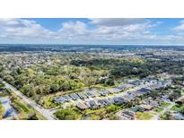 Stunning aerial view of the neighborhood with lush trees and serene ponds at 2538 Fireflag Ln, Sarasota, FL 34232