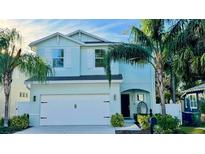Charming two-story home with a well-maintained lawn, lush landscaping and two car garage at 2904 N Ola Ave, Tampa, FL 33602
