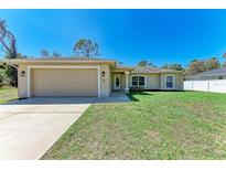 Charming single-story home featuring a well-maintained lawn, attached two-car garage, and neutral exterior paint at 3749 Albatros Ln, North Port, FL 34288