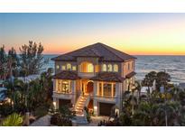 Stunning beachfront home featuring balconies and a private entrance, offering breathtaking ocean views at 3909 Casey Key Rd, Nokomis, FL 34275