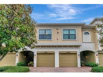 Charming two-story townhouse featuring a two-car garage and nicely landscaped front yard at 4210 Overture Cir, Bradenton, FL 34209