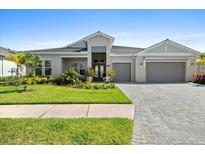 Beautiful single-story home with a well-manicured lawn and a two-car garage at 8227 Nevis Run, Bradenton, FL 34202