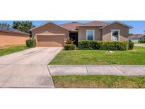 Charming single-story home with a well-manicured lawn and a two-car garage at 115 64Th E Ave, Bradenton, FL 34203