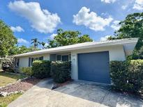 Charming single-story home featuring a clean front yard, lush landscaping, and a stylish attached garage at 1507 30Th W St, Bradenton, FL 34205