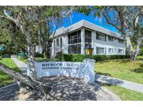 Inviting Baywood Colony condo featuring lush landscaping, and a well-maintained facade at 1711 Southwood St # 1711, Sarasota, FL 34231