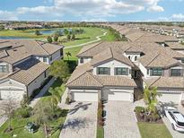 Stunning aerial view of homes overlooking the golf course and lake, showcasing a desirable community at 18117 Gawthrop Dr # 101, Lakewood Ranch, FL 34211