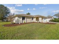 Charming single-story home with stone accents, well-maintained landscaping, and an attached two-car garage at 2412 15Th W St, Palmetto, FL 34221