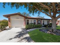 Charming single-story home featuring lush landscaping and a welcoming two-car garage at 3007 Vivienda Blvd # 3007, Bradenton, FL 34207