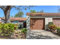 This home features a one-car garage with a brown door and well-maintained landscaping at 4423 Park Lake N Ter, Bradenton, FL 34209